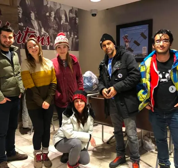 A group of animal rights activists posing for a photo, with one person wearing a t-shirt featuring the DandiLion logo from The Honest Whisper.
