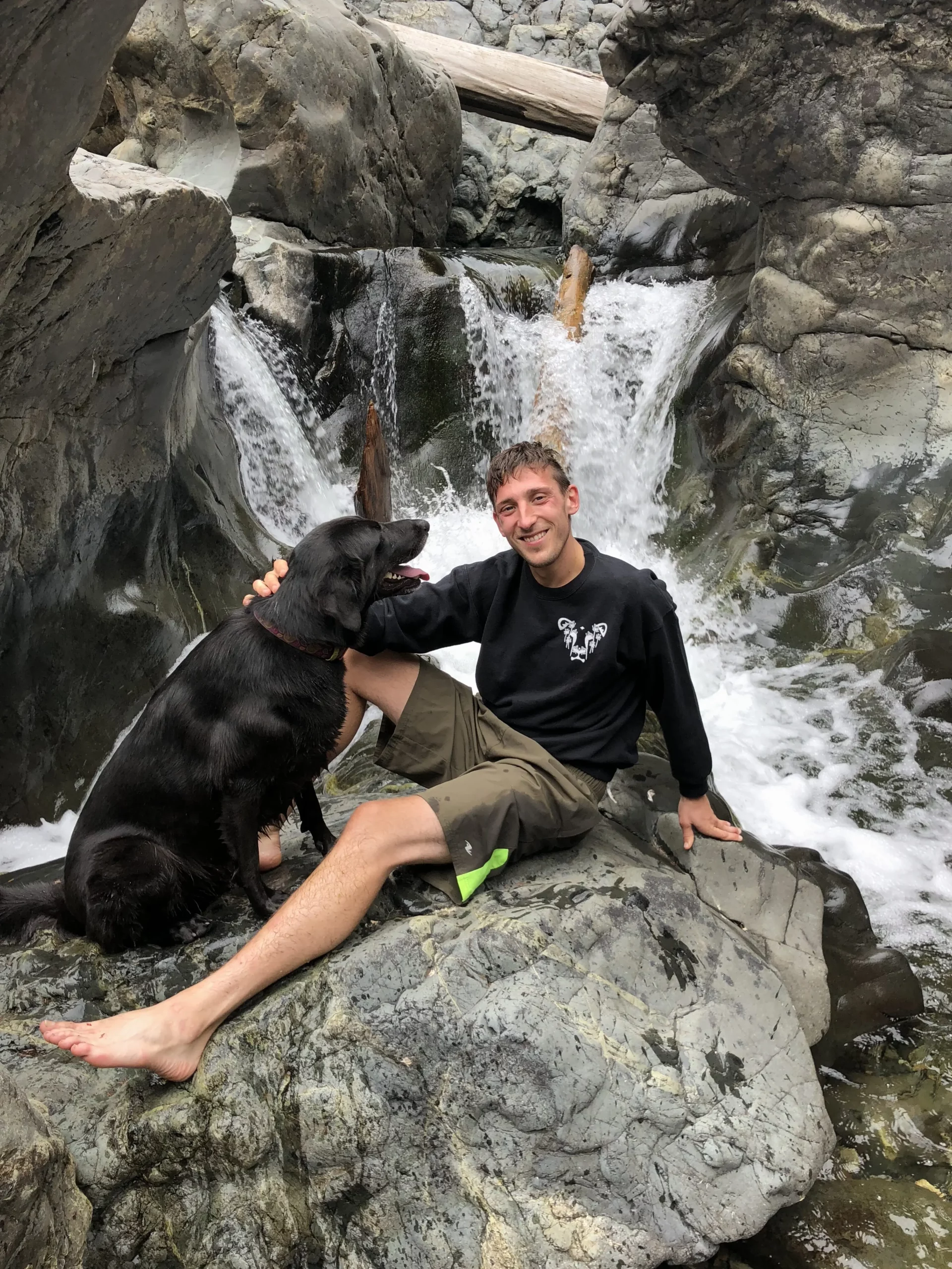 A man wearing a comfortable crew neck sweater featuring the Dandelion logo from The Honest Whisper, a brand known for its ethical and sustainable fashion.