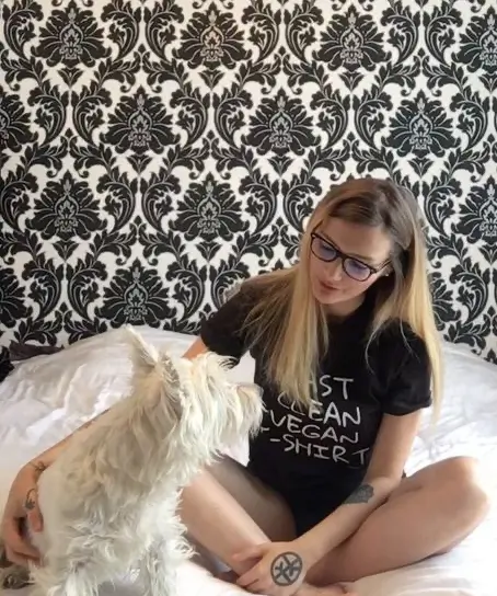 A young woman wearing a t-shirt with the message 