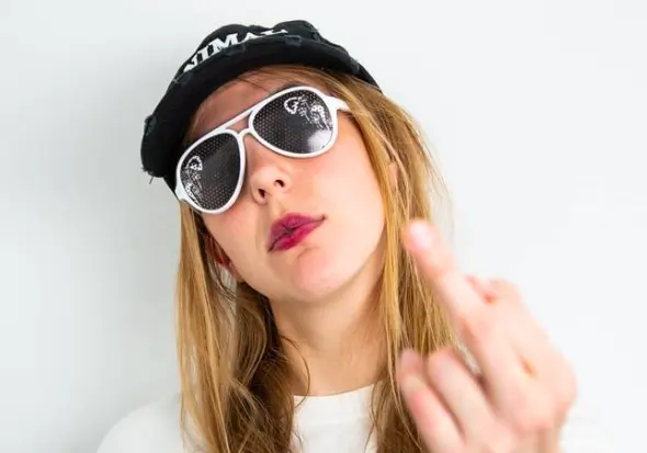 A woman wearing a black hat with the word 