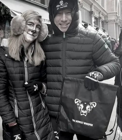A stylish bag from The Honest Whisper being held at an anti-fur activism event, promoting ethical and compassionate fashion choices.