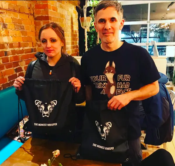 Len Goldberg and Ashley Ollie, supporters of The Honest Whisper, holding a bag from the brand.